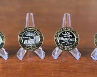A set of four limited edition $10 gaming tokens with .999 fine silver insert. Marked .999 fine silver on all four coins with a total approx. weight of 142.58 grams. Three are marked from Atlantis and the other Silver Legacy.