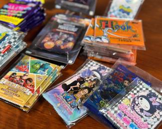 A huge collection of sealed trading card game packs including World of Warriors, Spongebob, Bill & Ted’s, HOOK, One Piece, & more.