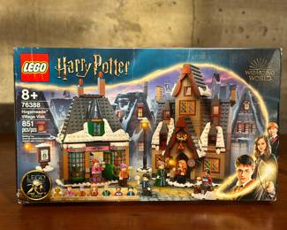An adult-owned (built-once) Lego Harry Pottery Hogsmeade Village Visit set (76388). Confirmed as a complete set, guaranteed by Salem Auction House with all the original packaging. Take a trip to Hogsmeade with Harry Potter and Dean Thomas. Buy tongue-tingling acid pops from Mrs. Flume at Honeydukes then go upstairs to help Mr. Flume make candy. Feeling thirsty? Try a Butterbeer at The Three Broomsticks where Professor McGonagall is chatting to Madam Rosmerta by the fire. Includes an exclusive golden anniversary Ron Weasley minifigure and 4 random wizard card tiles! Features a total of 851 pieces.