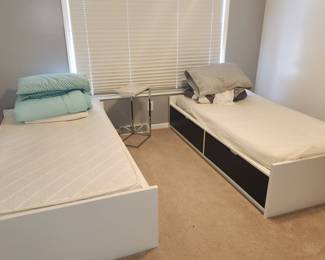 Twin beds with drawers underneath. 