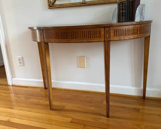 C1-$175. Wellington Hall Brand.  Hepplewhite Style Demilune Entry Table. One minor scratch noted on top. 