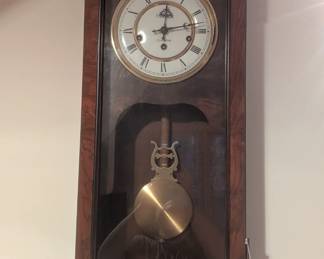 C69- $80.   Lancaster Wall Clock with key.  Measures 13" W x 6.5" D x 33.5" T