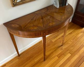 C1-$175. Wellington Hall Brand.  Hepplewhite Style Demilune Entry Table. One minor scratch noted on top. 