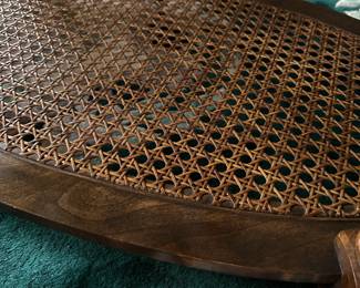 C43- $50.  Unmarked Oval Wooden and Caned Coffee Table.  Measures 46" long x 24" deep x 16.5" tall. 