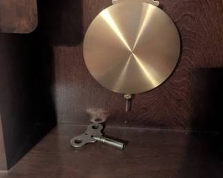 C69- $80.   Lancaster Wall Clock with key.  Measures 13" W x 6.5" D x 33.5" T