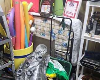 Roll away bed, pool noodles, and lake toys.