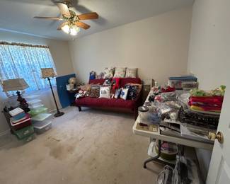 craft supplies, futon, lamps, globe, end tables, pillows