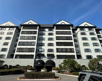 The front of the building. The main entrance is under the black canopy.