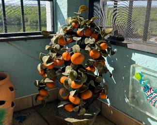 A very unique Florida orange tree. Leaves are fruit made from ceramic.