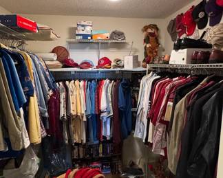 Closet featuring mostly mens clothes. Vintage hats and shirts present, including FSU merchandise.