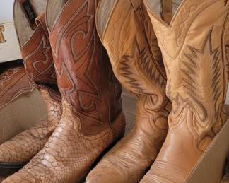 A selection of vintage men's cowboy boots in warm brown tones, featuring intricate stitching and embossed patterns.  Two vintage pairs new in box... Never worn...