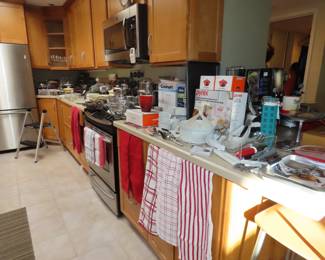 Very full kitchen with many items new in boxes.
