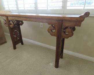Tall sofa table with carved legs.