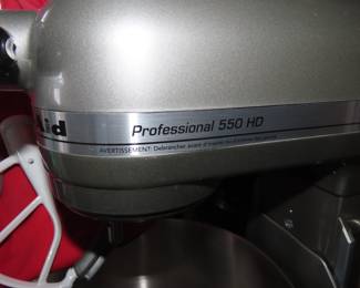 KitchenAid Professional 550 HD Mixer on stand with attachments.
