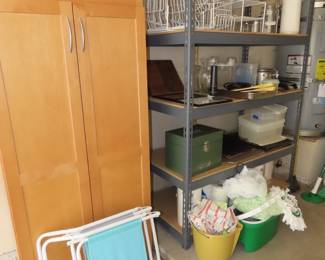 Metal and wood shelves. Plate racks. plastic containers. Cleaning supplies.