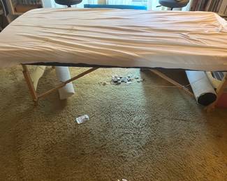 Portable Eartlite massage table with carry bag, head rests and other attachments.