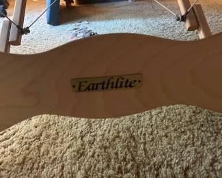 Portable Eartlite massage table with carry bag, head rests and other attachments.