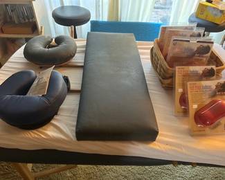 Portable Eartlite massage table with carry bag, head rests and other attachments.