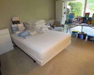 Queen size Tempurpedic mattress set.. New unopened pillows and sheets and blankets. White drawers, twin size sleeper sofa with linens. tables of office supplies.