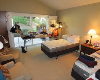 Two twin beds, tables of shoes. Pillows, bed linens.