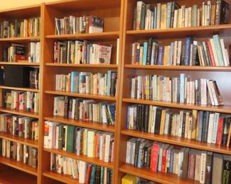 Teak bookcases and hundreds of books.