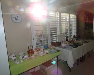 Tables of bone china and decorative items.
