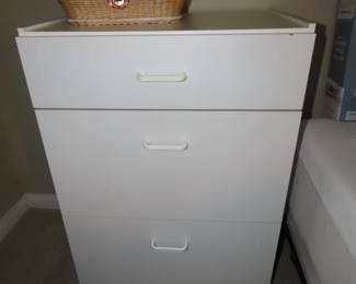 White drawers and sewing basket.