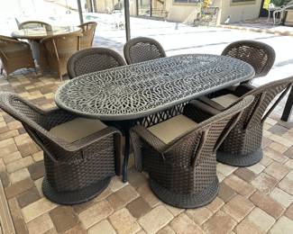 Outdoor Cast Aluminum Dining Set with 6 Wicker Rocking Swivel Chairs, Table: 41 1/2" w x 29 1/2" h x 83" d Chair: 29" w x 34 1/2" h x 25" d, $895