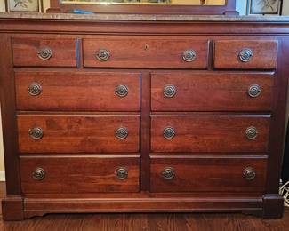 Solid wood dresser with ornate handles and marble top