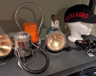 Vintage flashlights, lanterns, Marlboro cap, fishing reels