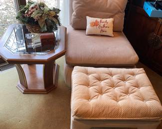 Light pink cushioned chair with matching footrest - wooden 80s end table with glass top