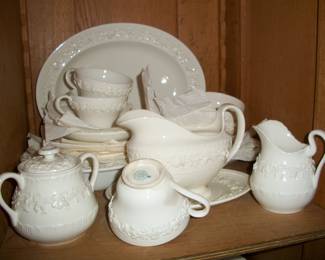 64pcs. Vintage Wedgwood Embossed "Queens Ware" Dinnerware set, shown by shelf.