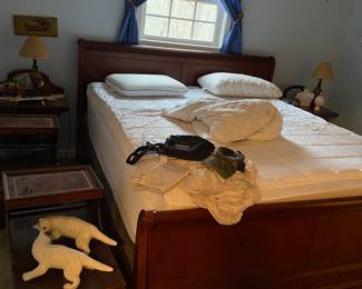 Sleigh bed, leather top end tables.