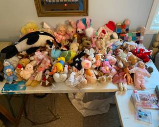 Table full of dolls snd stuffed animals