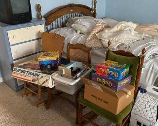 Miscellaneous games, bed, chest of drawers.
