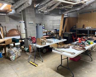 Garage area with tools, player piano and train table with trains