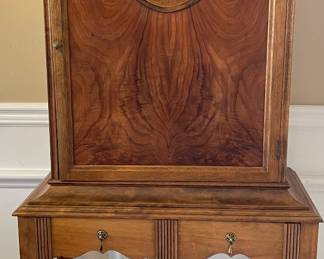 Stepped back bar or cabinet with a single drawer in the front apron area. The interior has shelves.