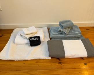 bathroom rugs and towels - several sets in both white and blue, plus grey and white shower curtain