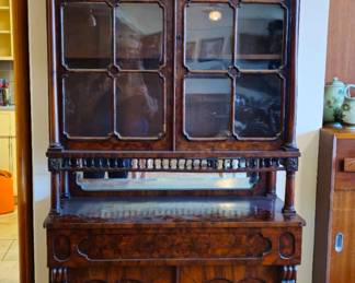 Mid size hutch or china cabinet with drawer and storage shelves. Overall  parquetry veener.