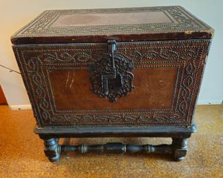 18th century leather flat top traveling chest on stand. Leather damaged right front top corner showing wood. Skuffs and scratches  in various places. Very thin leather over pine. No key.