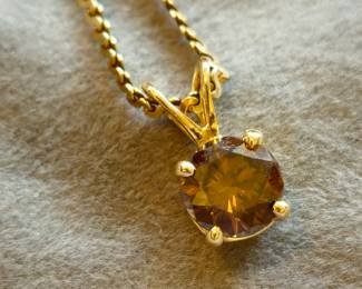 Brown diamond in 14k basket mount  on 14k chain. Approx 1 carat.
