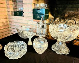 Punch cups in background. Cut glass punch bowl on pedestal.