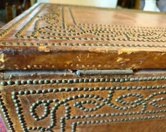 Leather is damaged in several areas along the top edge with one large area on right front corner