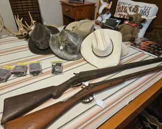 Guns to use as decor above the fireplace. Antler wall scones. Boy Scout bolo and buckle 1962 , 1985, and other dates. Resistol and Stetson hats.