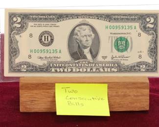 Two consecutive serial numbered $2 bills