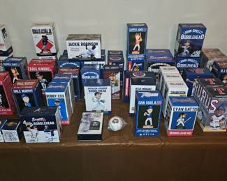 Large collection of Atlanta Braves bobbleheads and other sports memorabilia in original boxes, plus vintage Sports Illustrated magazines.