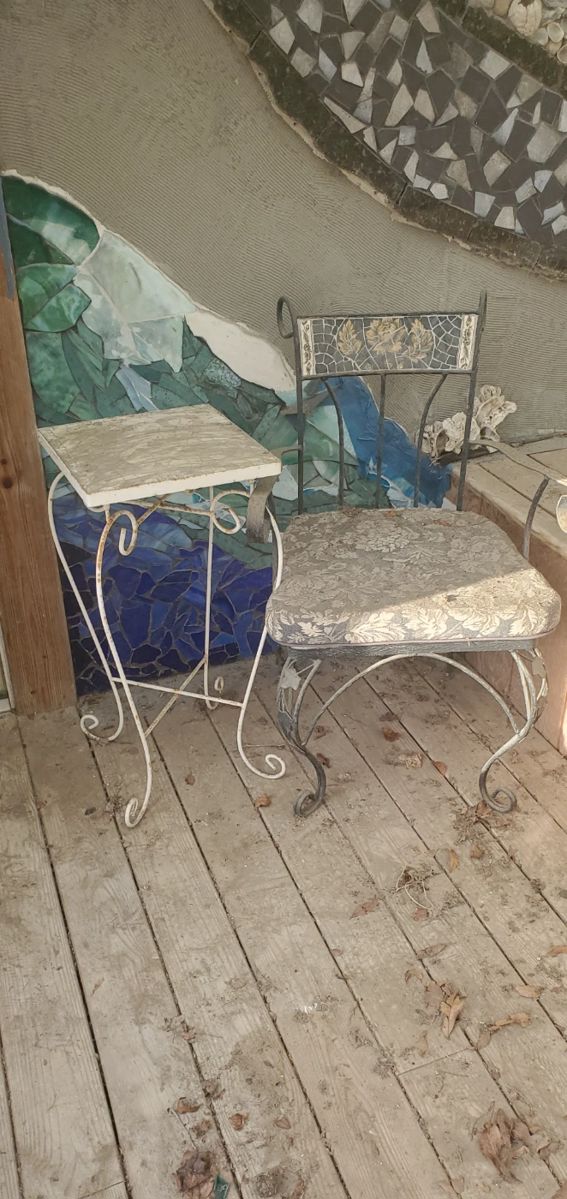 wrought iron end table, chair with tile mosaic