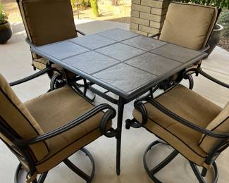 39" SQUARE TILE TOP PATIO TABLE WITH 4 SWIVEL ROCKER CHAIRS.  $250 AVAILABLE FOR IMMEDIATE PURCHASE WITH PICK UP DURING THE SALE
