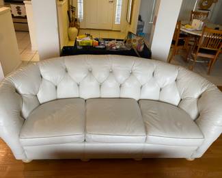 There are two of these sofas.  They are Top Grade Leather made by Hugo’s in Jacksonville.  Chesterfield model.  In great shape.