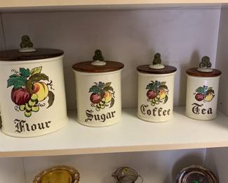 Merlot poppy tail canister set of 4 w fruit decor and wooden lids w ceramic knobs. No cracks or chips. 